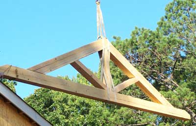 Antique Heart Pine Truss being lifted into place on house in Columbus, MS